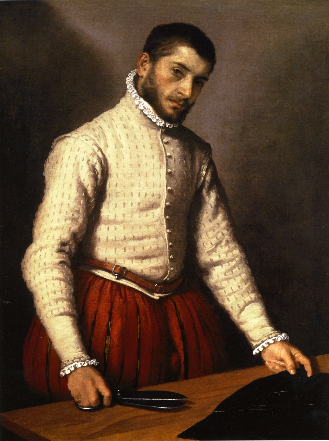 Giovanni Battista Moroni's portrait of a tailor standing over black cloth with a large pair of shears.